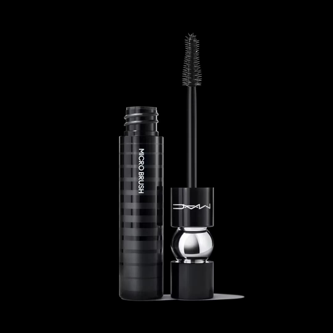 An open tube of black mascara from MAC against a light gray background
