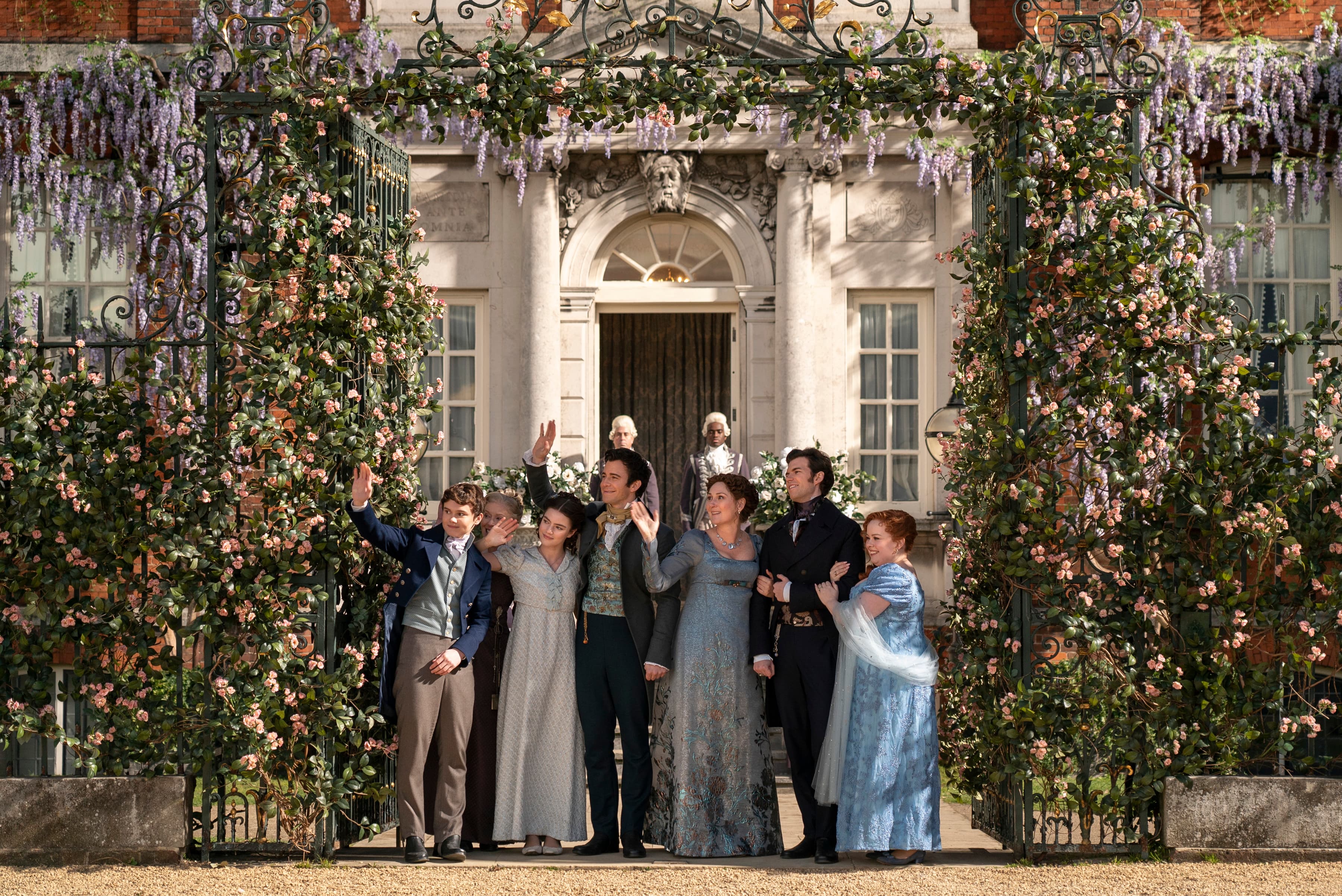 The Bridgerton family outside their signature wisteria-covered home.
