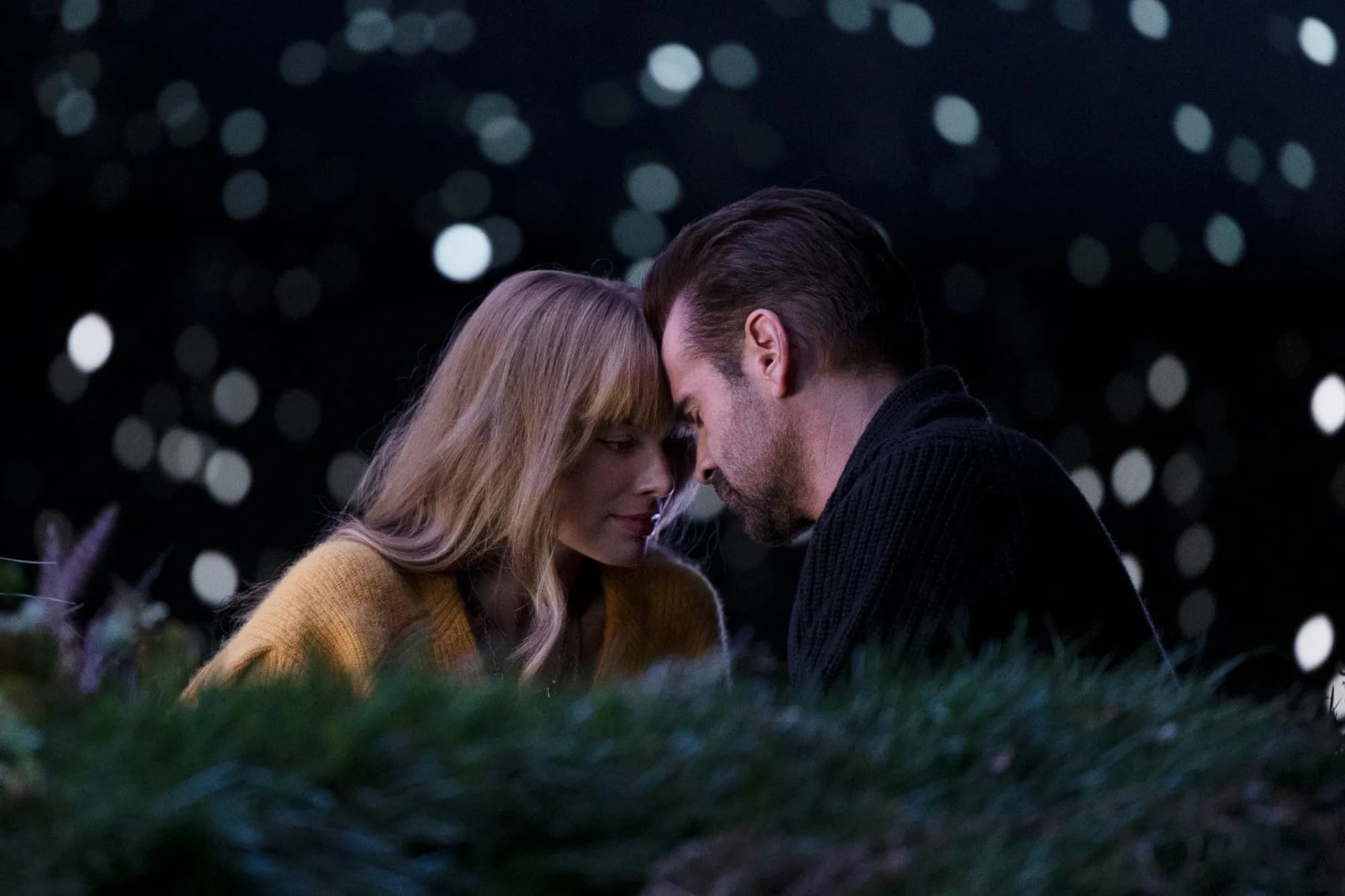 Margot Robbie and Colin Farrell sit with their foreheads touching in a still from "A Big Bold Beautiful Journey."