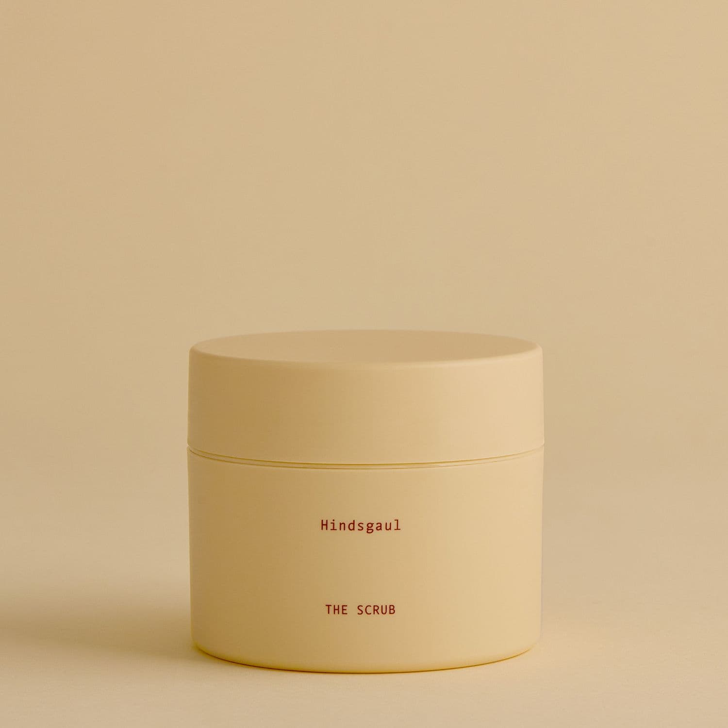A closed jar of the Hindsgaul Hair The Scalp Scrub Shampoo against a pale yellow background
