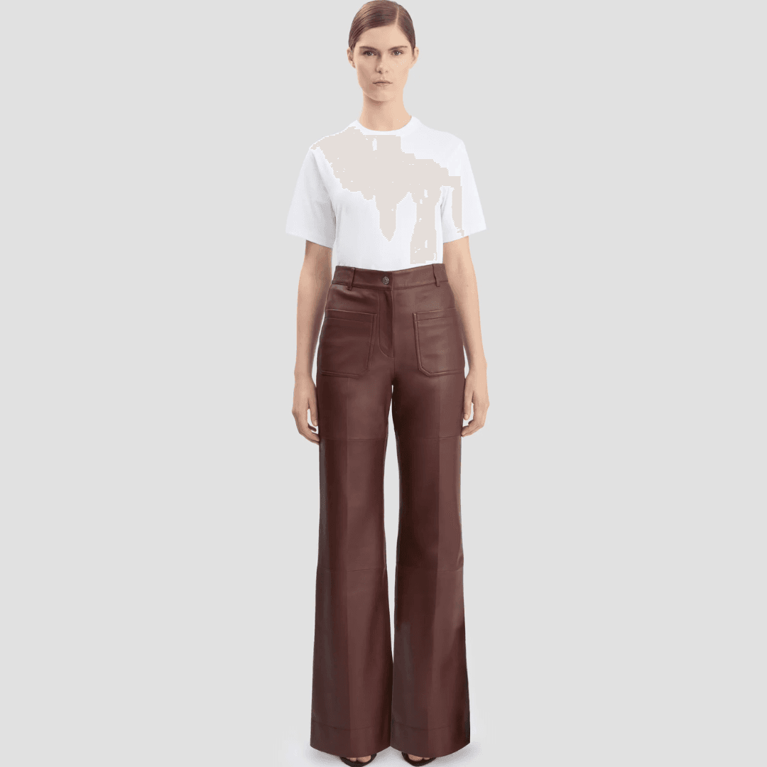A models wears the Victoria Beckham Leather Alina Trouser In Burgundy and a white top